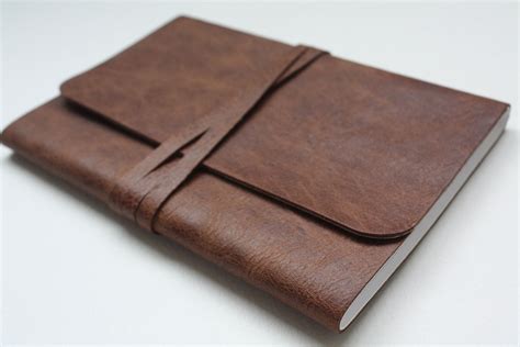 gray notebook with brown leather flap